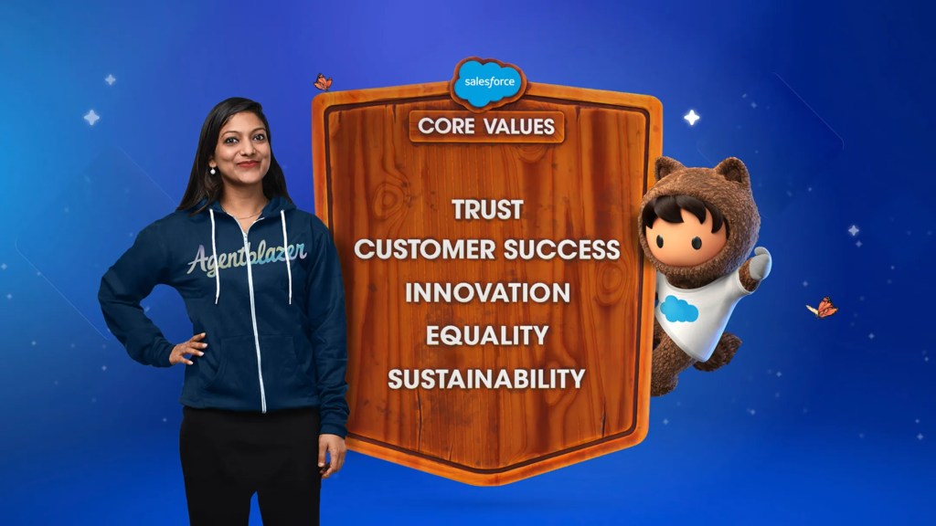 An Agentblazer and Salesforce mascot Astro stand beside a plaque featuring our core values: trust, customer success, innovation, equality and sustainability.